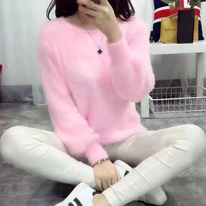 a young woman wearing a pink fluffy pullover 