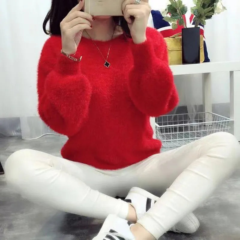 a young woman wearing a red fluffy sweater 