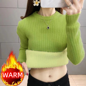 a cute young lady wearing a green sweater with fleece 
