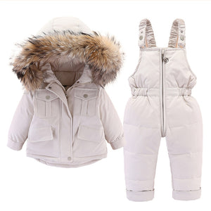this picture is presenting a white Snow Toddler Puffer Jacket and Winter Jumpsuit suit with beautiful fur on the hood edge