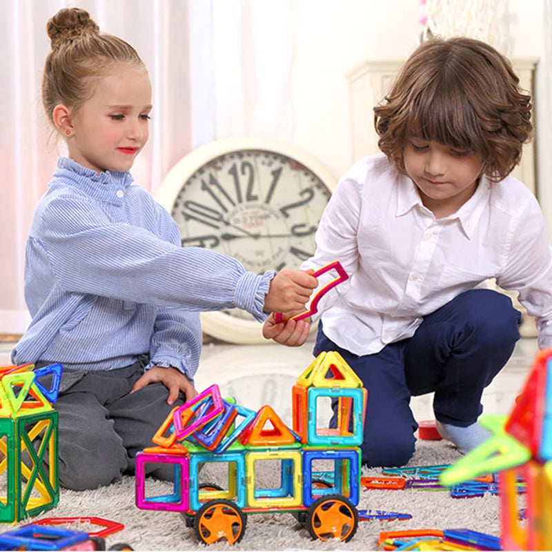 a boy and a girl are learning teamwork while playing with our Magnetic Building Squares | Educational Toys