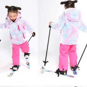 front and back view of a 9 year old girl wearing her pink snowsuit
