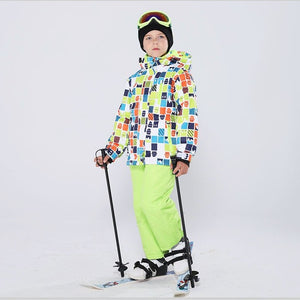 a 9 year old boy wearing his light green ski jacket and pants set