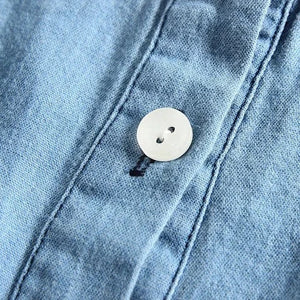 the picture is taking a close look at button closure and neat seams of our brand new Denim Cowgirl Dress for 3-4 year old girls
