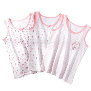 3 white tanks with pink details lieing flat on  white background