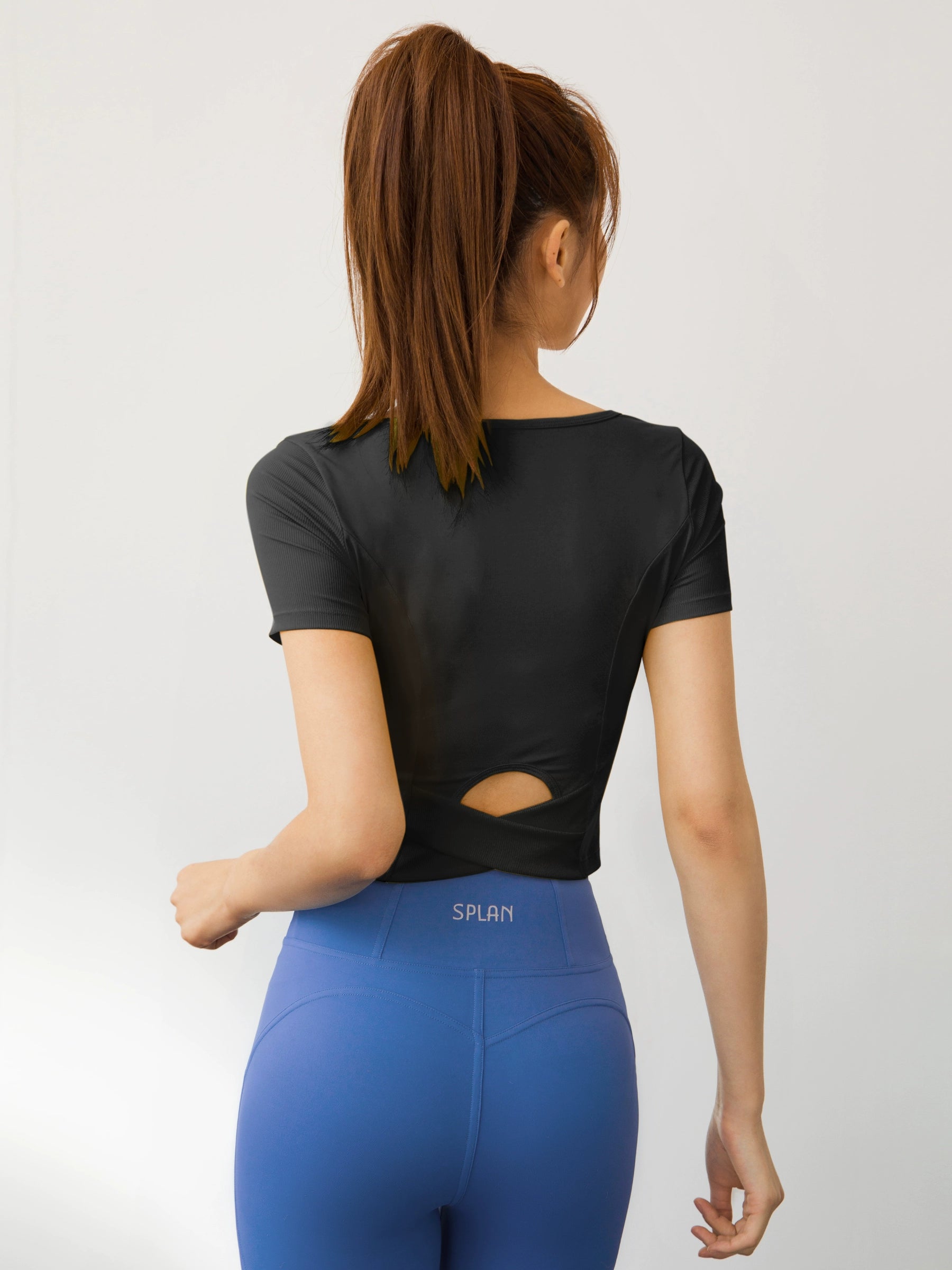 back view of a teenage girl wearing a T-shirt Nude Feel for Yoga color black
