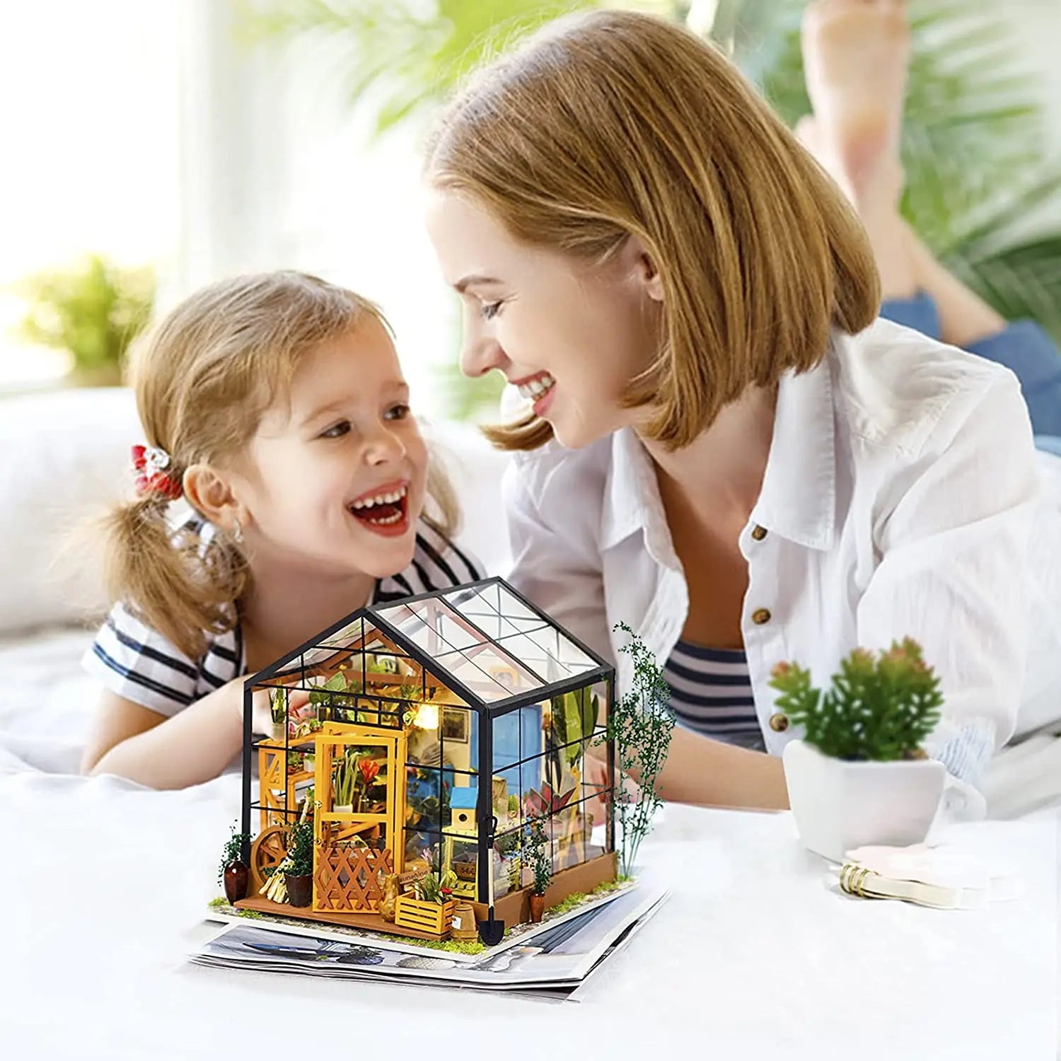 a happy mom and daughter are having great fun playing with DIY Doll House Kit