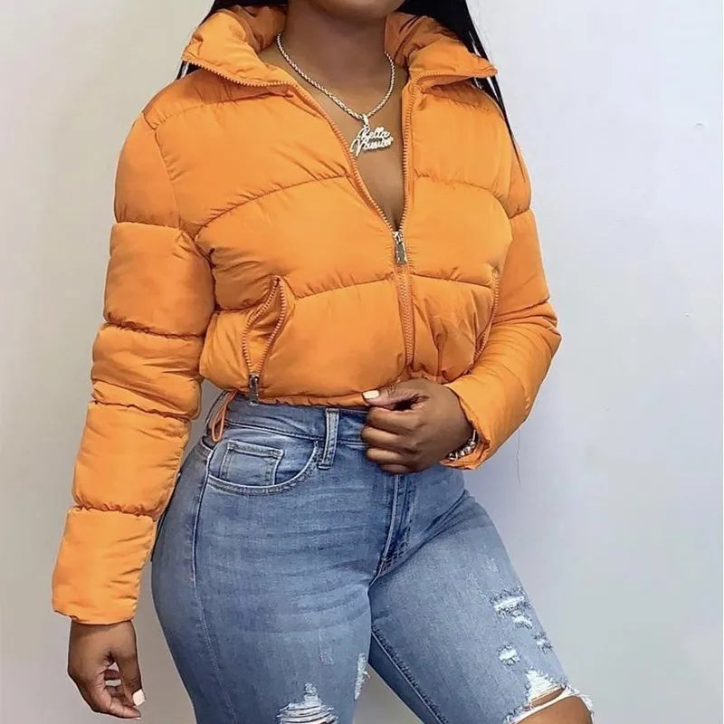 a beautiful woman wearing a half-unzipped cropped puffer color orange 