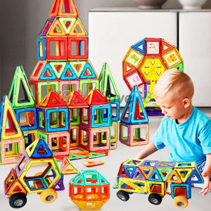 a cute 5 year old boy happily playing with huge set Magnetic Building Squares
