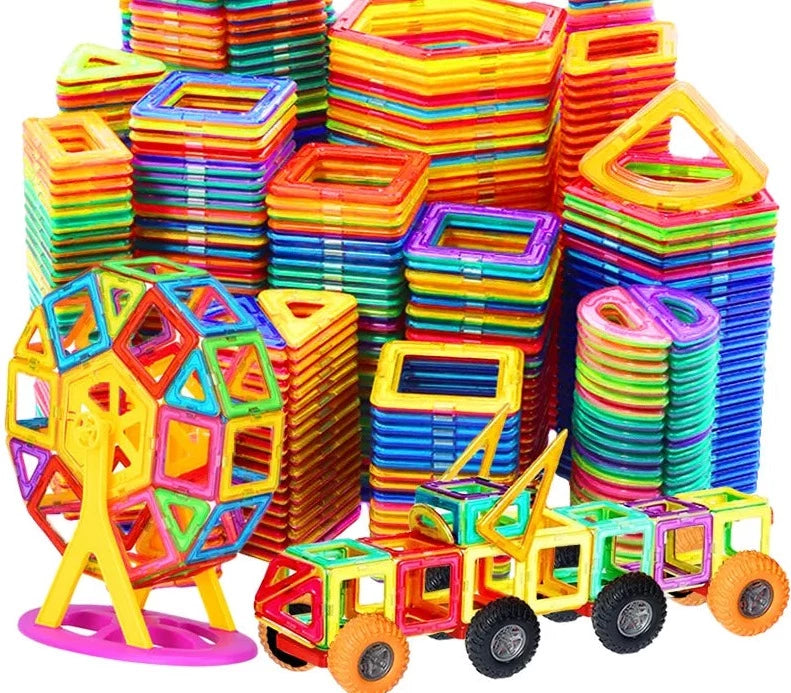 huge ammount of Magnetic Building Tiles in piles at the background and 2 toys made up of these tiles in front