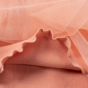 this picture is taking a closer look at neat overlock seam at the bottom edge of the non see through lining of the tu-tu skirt of toddler girl dresses color pink