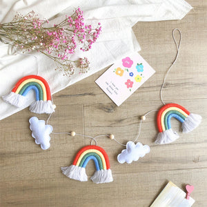 Pastel rainbow & plush clouds dance across this serene felt wall hanging, calming even the tiniest dreamers. 