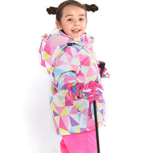 a happy 7 year old girl wearing a pink ski jacket and pants set