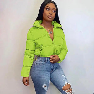 a beautiful woman wearing a half-unzipped women short puffer jacket color neon green