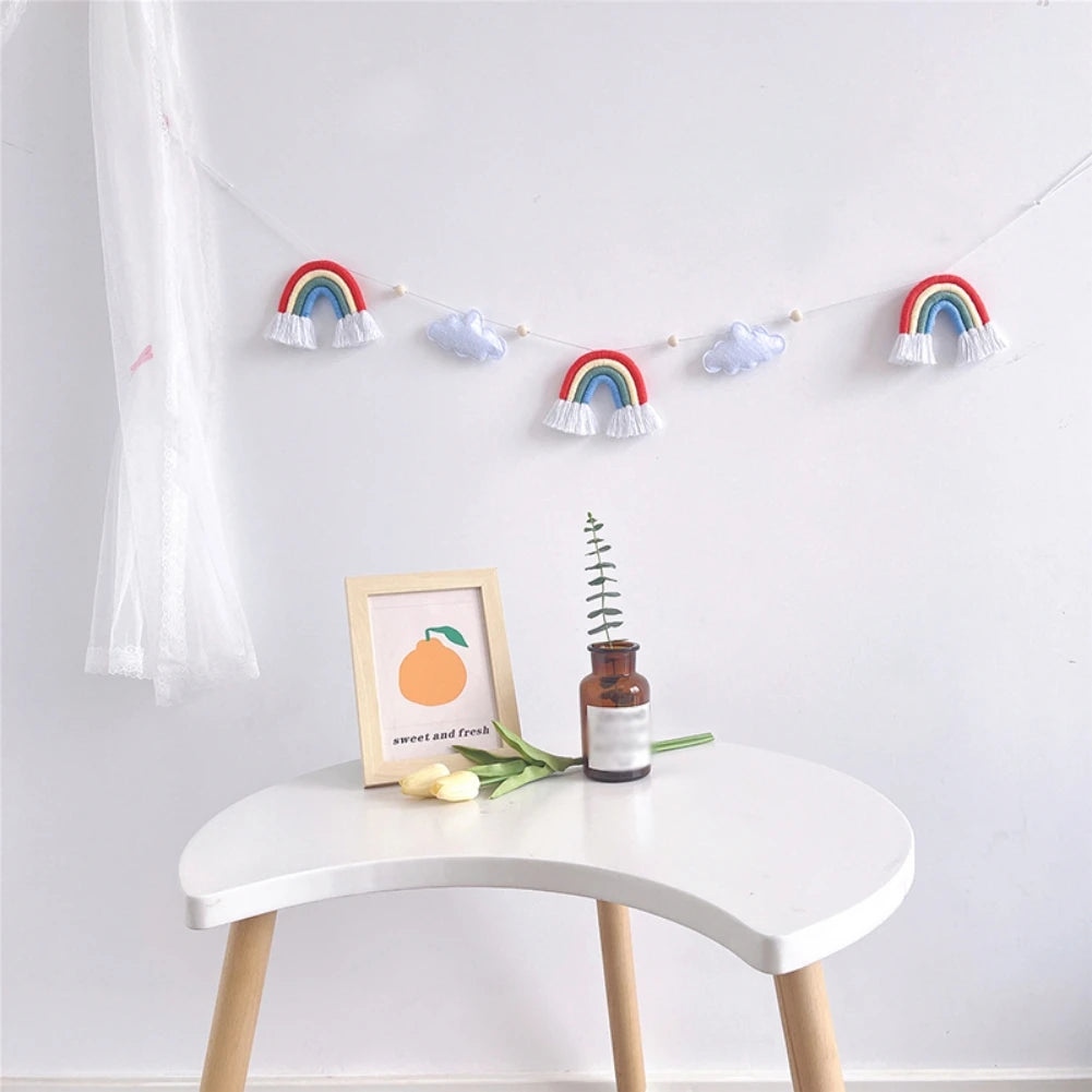 Transform any wall into a calming haven! This soothing felt rainbow & cloud wall hanging is a nursery essential. 