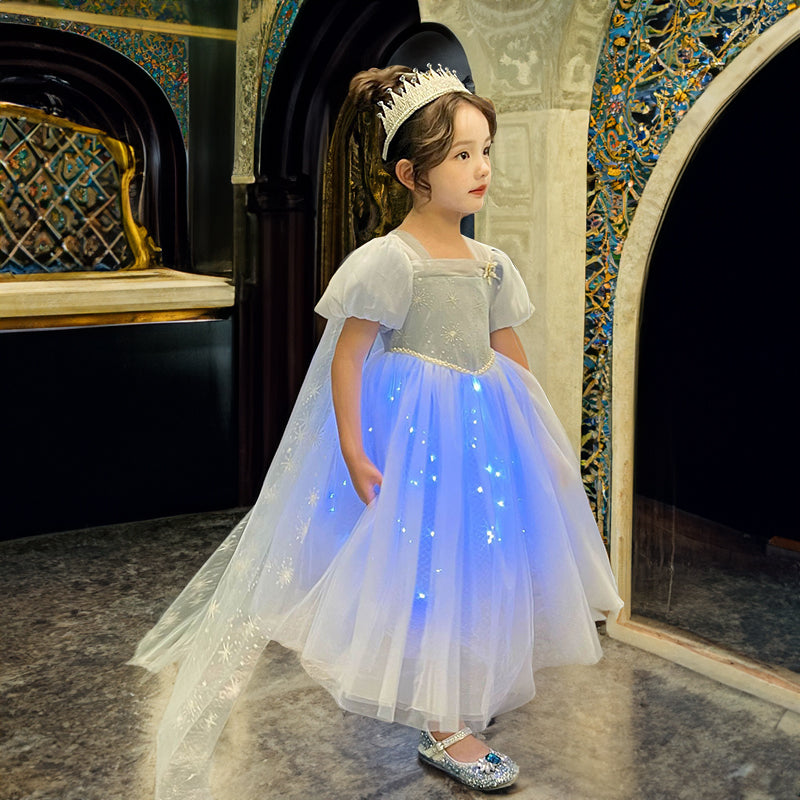 a cute 8 year old girl wearing a Light Up Princess Dress in a royal enviroment