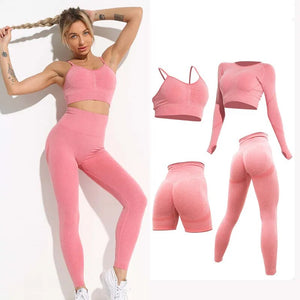 this picture is showing front view of a beautiful young woman with gorgeous figure wearing a yoga suit color light pink. the yoga suit set consists of 4 tems: a pasta top, a long sleeve top, a pair of shorts with butt push up effect and a pair of pants with high waist to flatten your belly and butt push up effect.
