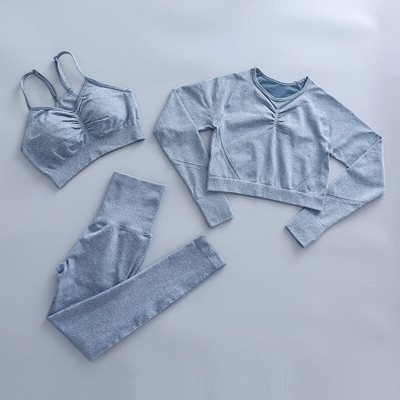 this picture is showing a color light blue yoga suit set consisting of 3 tems: a pasta top with bust suppert, a long sleeve top and a pair of pants with high waist to flatten your belly and butt push up effect.