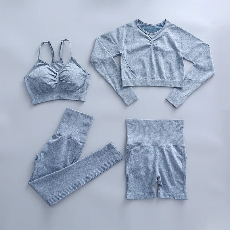 this picture is showing a color light blue yoga suit set consisting of 3 tems: a pasta top with bust suppert, a long sleeve top, a pair of shorts and a pair of pants with high waist to flatten your belly and butt push up effect.
