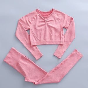this picture is showing a color light pink yoga suit set consisting of 2 tems: a long sleeve top and a pair of pants with high waist to flatten your belly and butt push up effect.