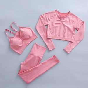 this picture is showing a color light pink yoga suit set consisting of 3 tems: a pasta top with bust suppert, a long sleeve top and a pair of pants with high waist to flatten your belly and butt push up effect.