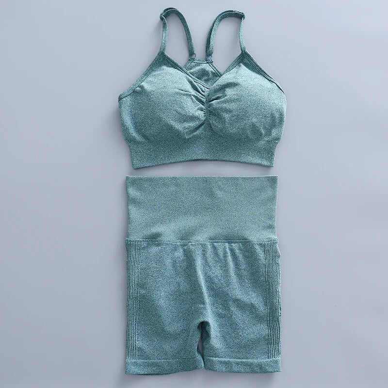 this picture is showing a color light green yoga suit set consisting of 2 tems: a pasta top and a pair of shorts with high waist to flatten your belly and butt push up effect.