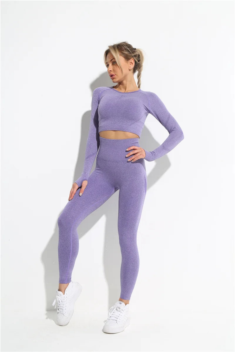 this picture is showing a beautiful young woman with gorgeous figure wearing a yoga suit color light purple. the yoga suit set consists of 2 tems: a pasta top and a pair of pants with high waist to flatten your belly and butt push up effect. front view