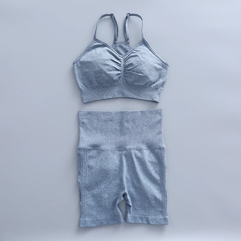this picture is showing a color light blue yoga suit set consisting of 2 tems: a pasta top and a pair of shorts with high waist to flatten your belly and butt push up effect.