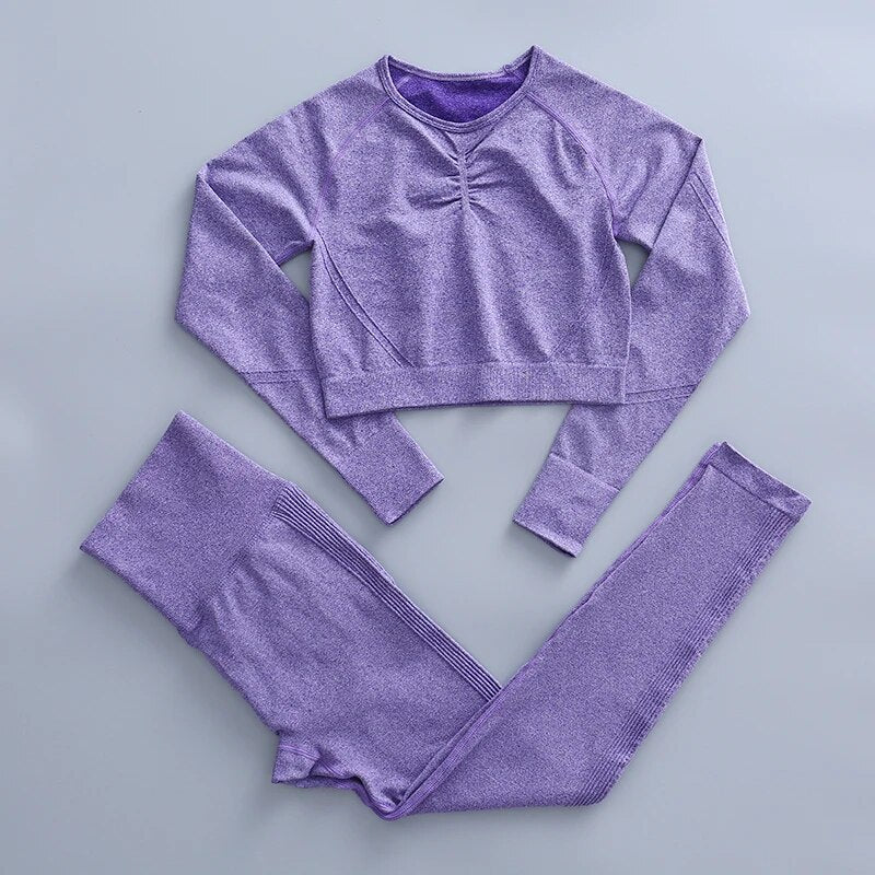 this picture is showing a color light purple yoga suit set consisting of 2 tems: a long sleeve top and a pair of pants with high waist to flatten your belly and butt push up effect.