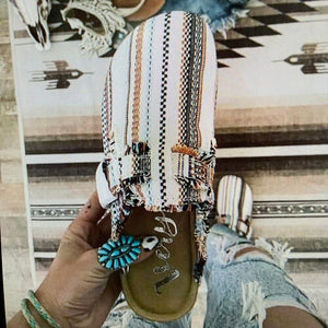 indian woman holding in hand native american style clogs 