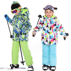 a happy girl and a upbeat boy wearing a ski jacket and pants set for kids
