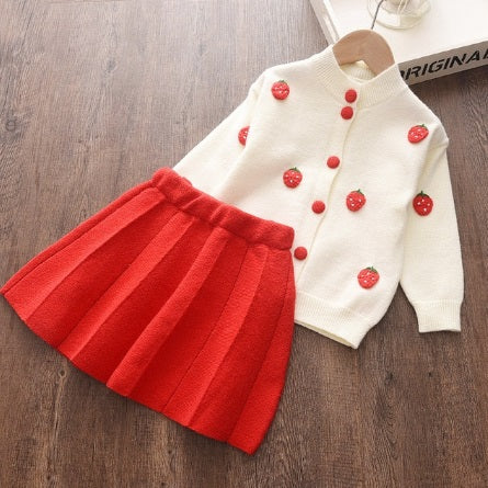 cream color Knitted Cardigan with 3d strawberry  knit decor and matching color button closure and light red pleated Skirt 2 piece set for girls 5-6 years old