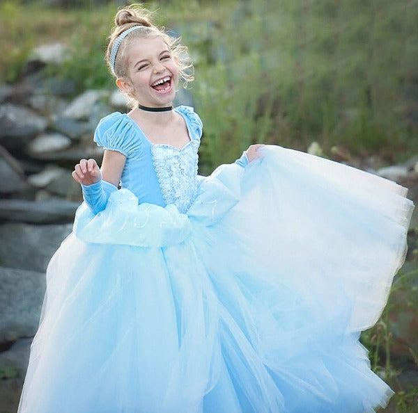 a cuteand really happy 8 year old girl is swhirling in her brannd new Ball Gown | Special Occasion Dress in sky bluee color
