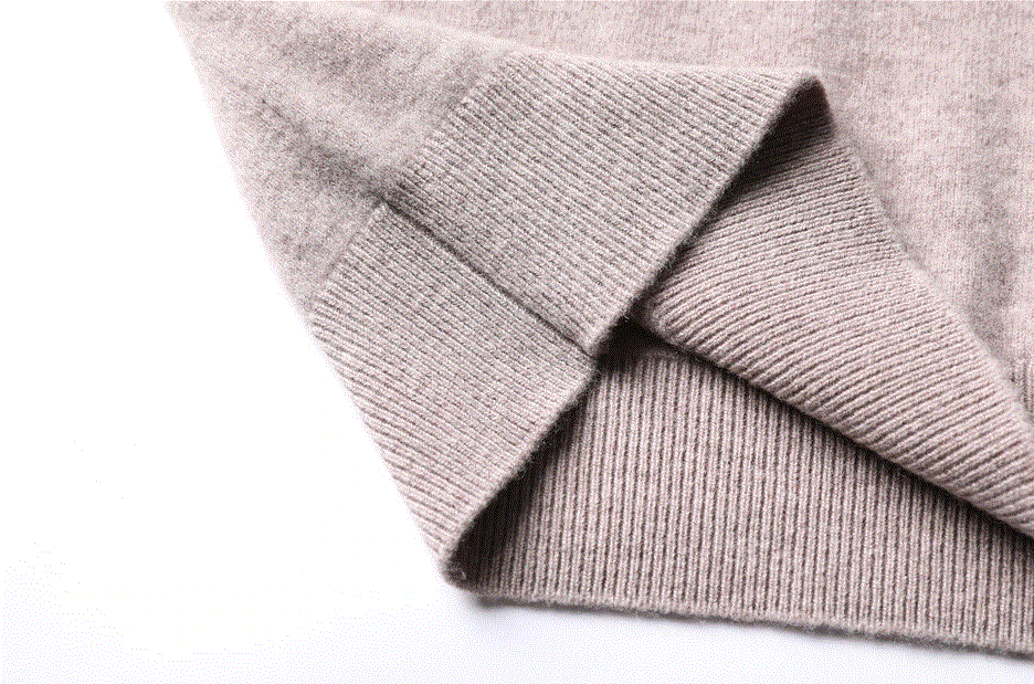 detailed view of elastic waist and side seam of wool high neck sweater 